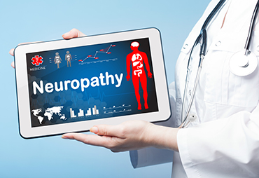 doctor showing patient causes of peripheral neuropathy